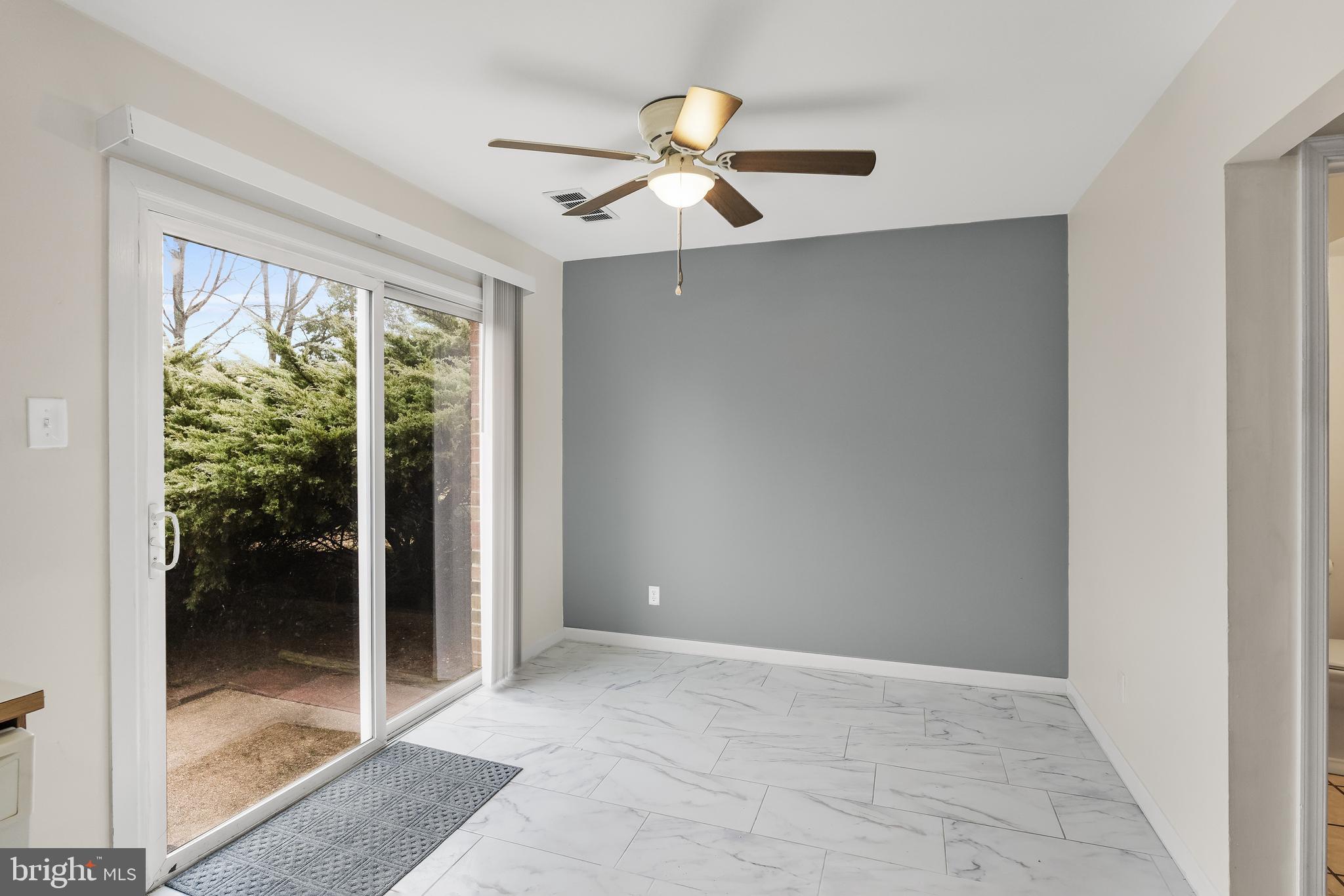 19 Turtle Creek Drive Medford, NJ 08055 - Photo 3 of 9 a view of an empty room with glass door and a ceiling fan