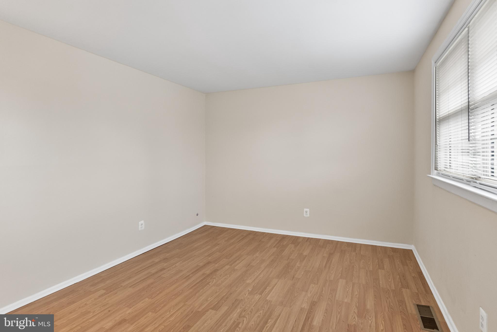 19 Turtle Creek Drive Medford, NJ 08055 - Photo 5 of 9 an empty room with wooden floor and windows