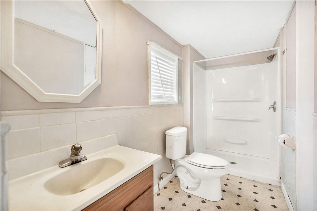 1004 Wiles Road Anderson, SC 29625 - Photo 16 of 26 A well-lit bathroom with practical tile flooring and a functional shower unit.