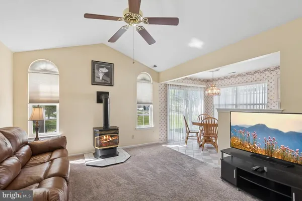 a living room with furniture a window and a flat screen tv