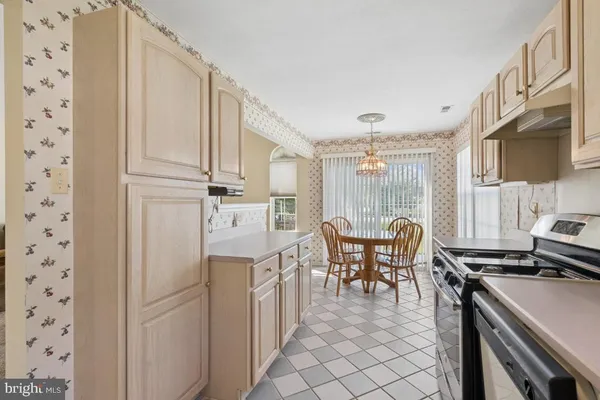 a dining room with furniture a window and a kitchen view