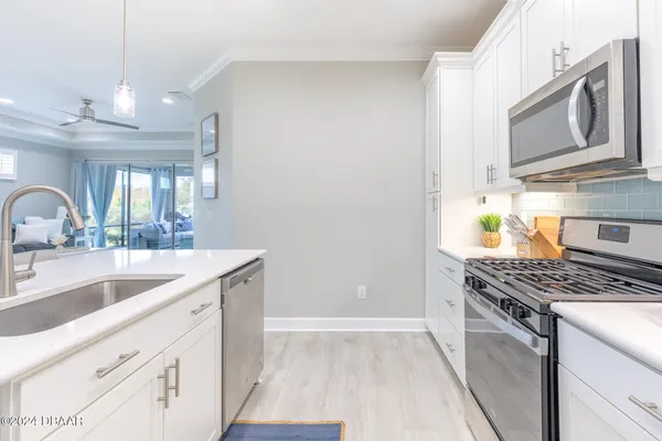 a kitchen with stainless steel appliances granite countertop a sink stove and cabinets