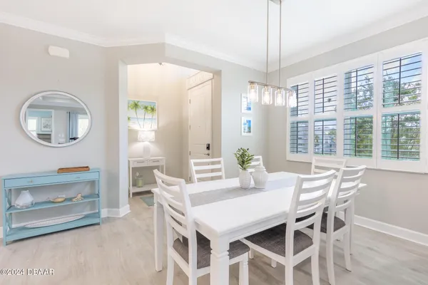 a view of a dining room with furniture and a chandelier