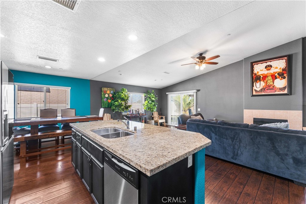 37068 Waltham Place Palmdale, CA 93550 - Photo 17 of 36 a view of kitchen island a sink and living room view