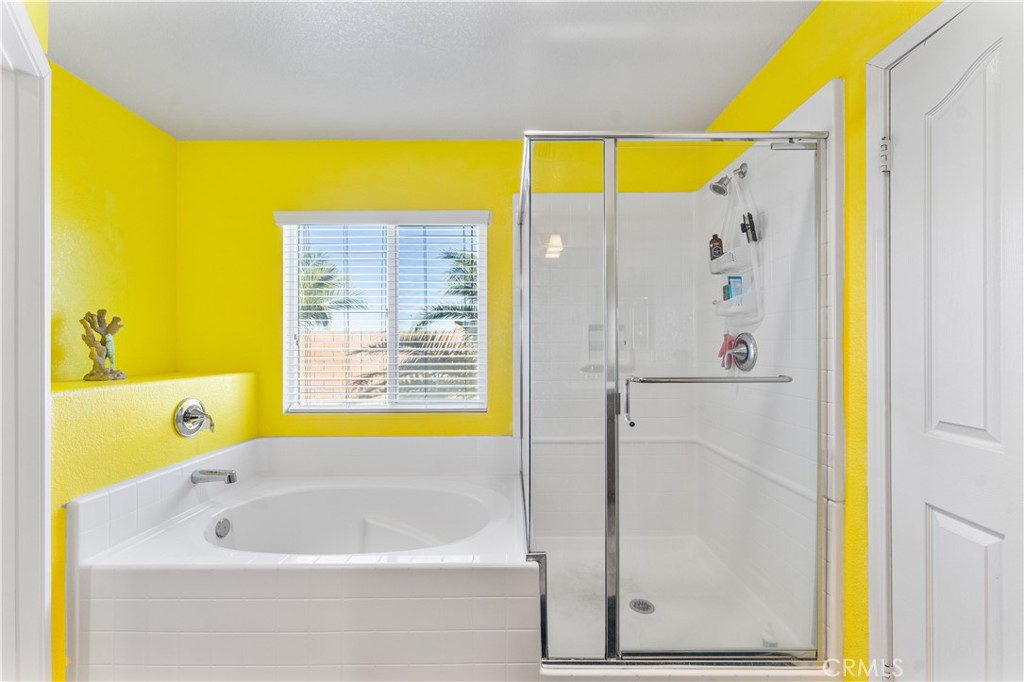37068 Waltham Place Palmdale, CA 93550 - Photo 22 of 36 a bathroom with a bathtub and a shower