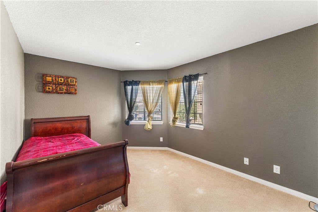 37068 Waltham Place Palmdale, CA 93550 - Photo 23 of 36 a bedroom with a bed and window