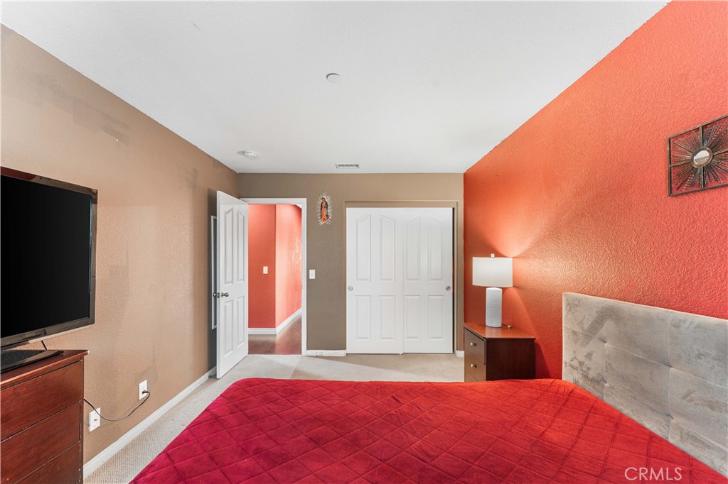 37068 Waltham Place Palmdale, CA 93550 - Photo 26 of 36 a bedroom with a bed and a flat screen tv