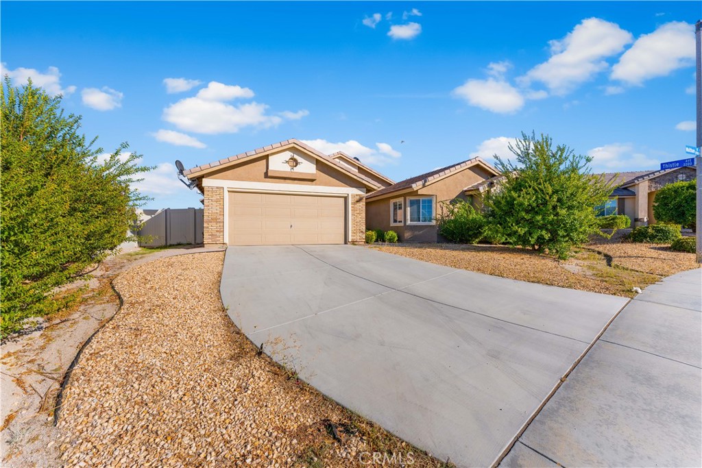 37068 Waltham Place Palmdale, CA 93550 - Photo 3 of 36 a front view of a house with a yard