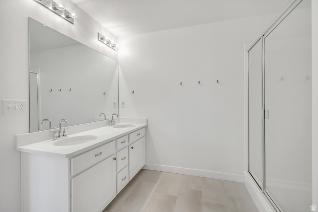 1058 Lilac Way Mapleton, UT 84664 - Photo 12 of 28 Bathroom with double vanity and a shower stall