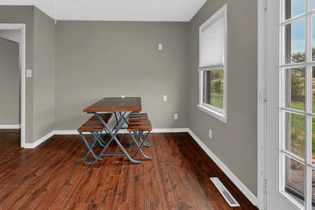 a work room with furniture and wooden floor
