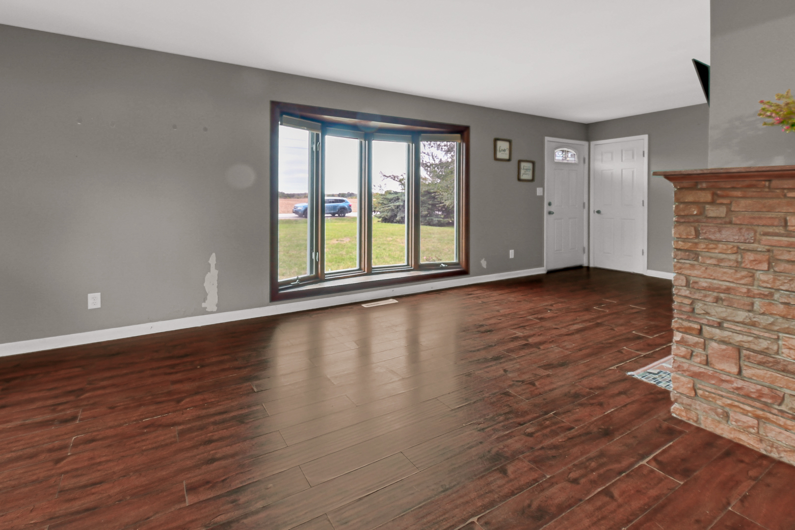 59 North 2750W Road Kankakee, IL 60901 - Photo 4 of 19 a view of an empty room with wooden floor and a window