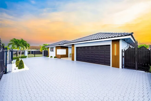 a view of house with backyard and a garden