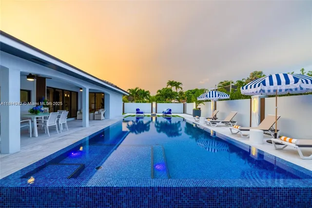 a view of a swimming pool with outdoor seating