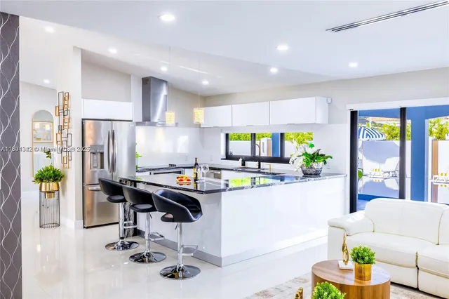 a kitchen with stainless steel appliances kitchen island granite countertop a sink and cabinets