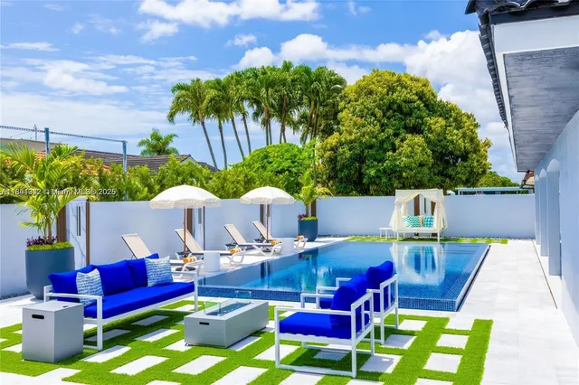 a view of a patio with table and chairs potted plants with wooden floor