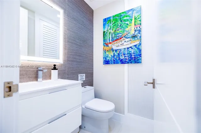 a bathroom with a sink a toilet and a window