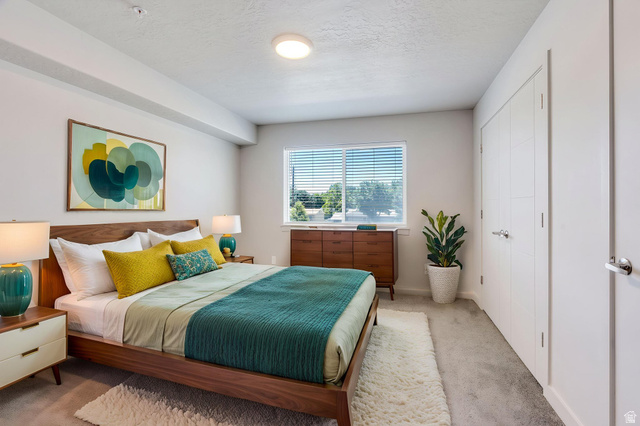 572 South 100 West, Unit E210 Springville, UT 84663 - Photo 23 of 35 Bedroom featuring a large window with blinds, light gray carpet, and white walls