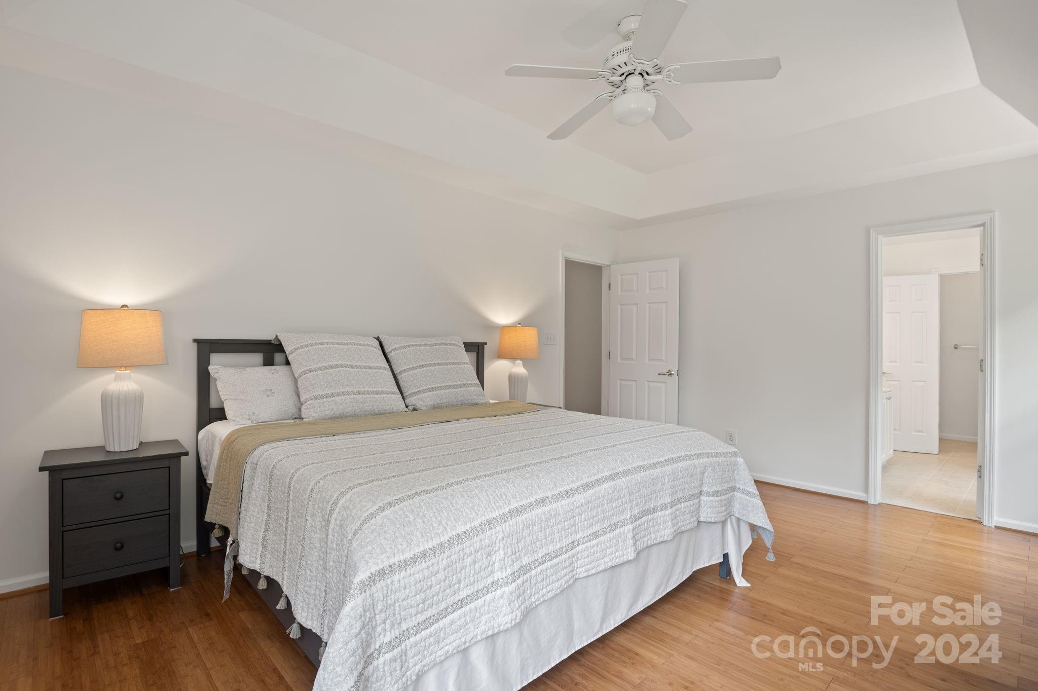 736 West Cheval Drive Fort Mill, SC 29708 - Photo 27 of 44 a bedroom with a bed and wooden floor
