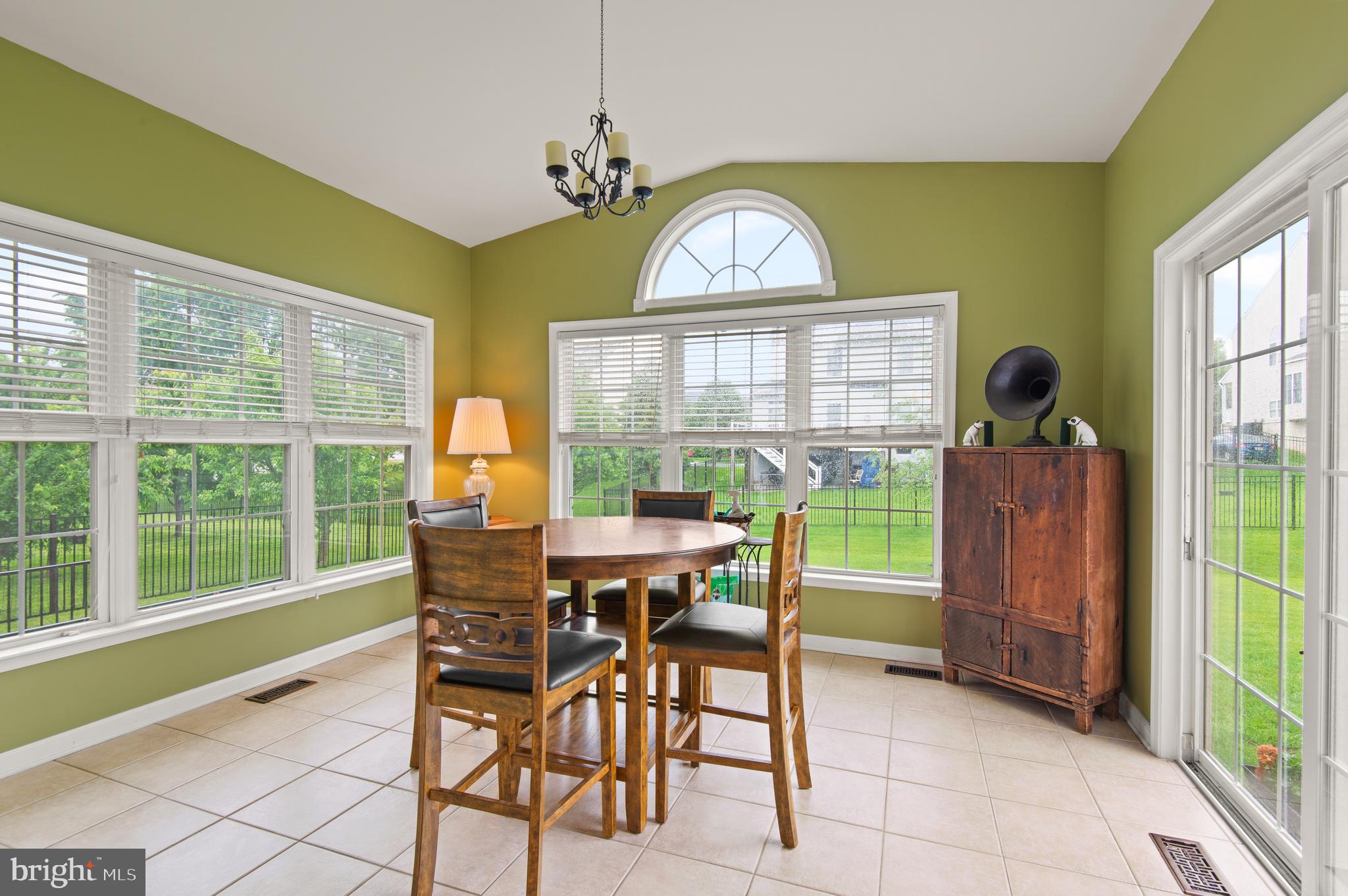 985 Silver Maple Circle Seven Valleys, PA 17360 - Photo 13 of 50 a view of a dining room with furniture a chandelier and wooden floor