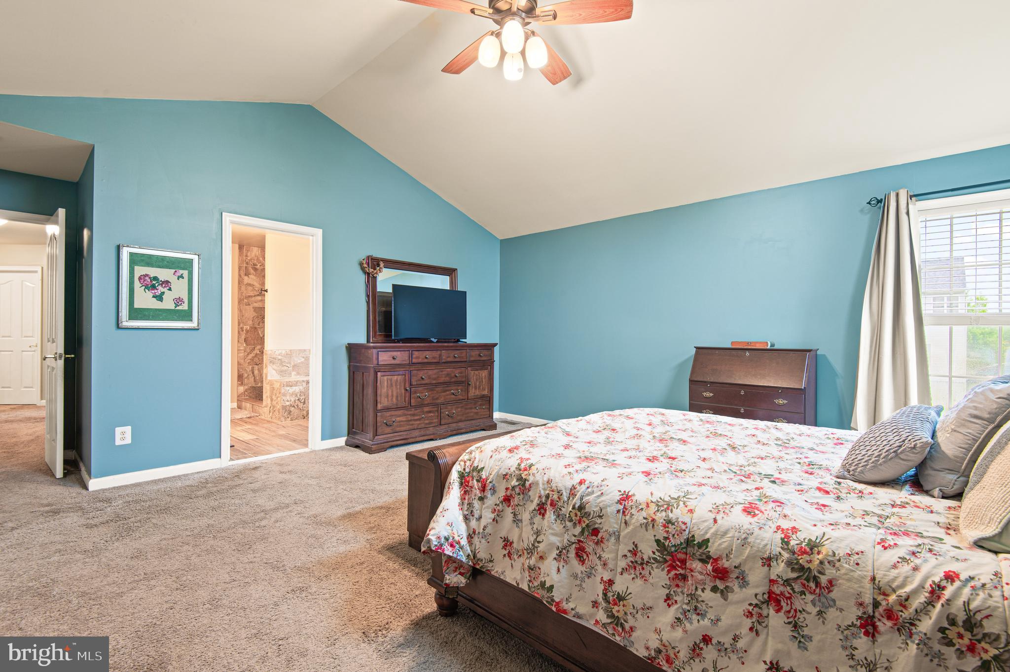 985 Silver Maple Circle Seven Valleys, PA 17360 - Photo 20 of 50 a bedroom with a large bed and a chandelier