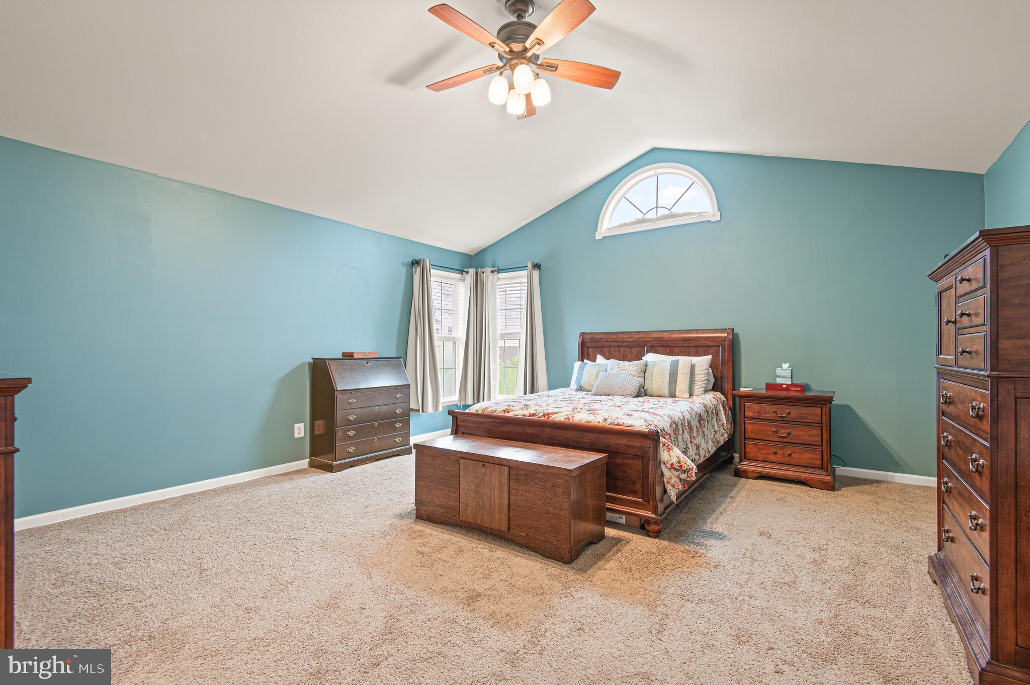 985 Silver Maple Circle Seven Valleys, PA 17360 - Photo 22 of 50 a spacious bedroom with a bed and a chandelier