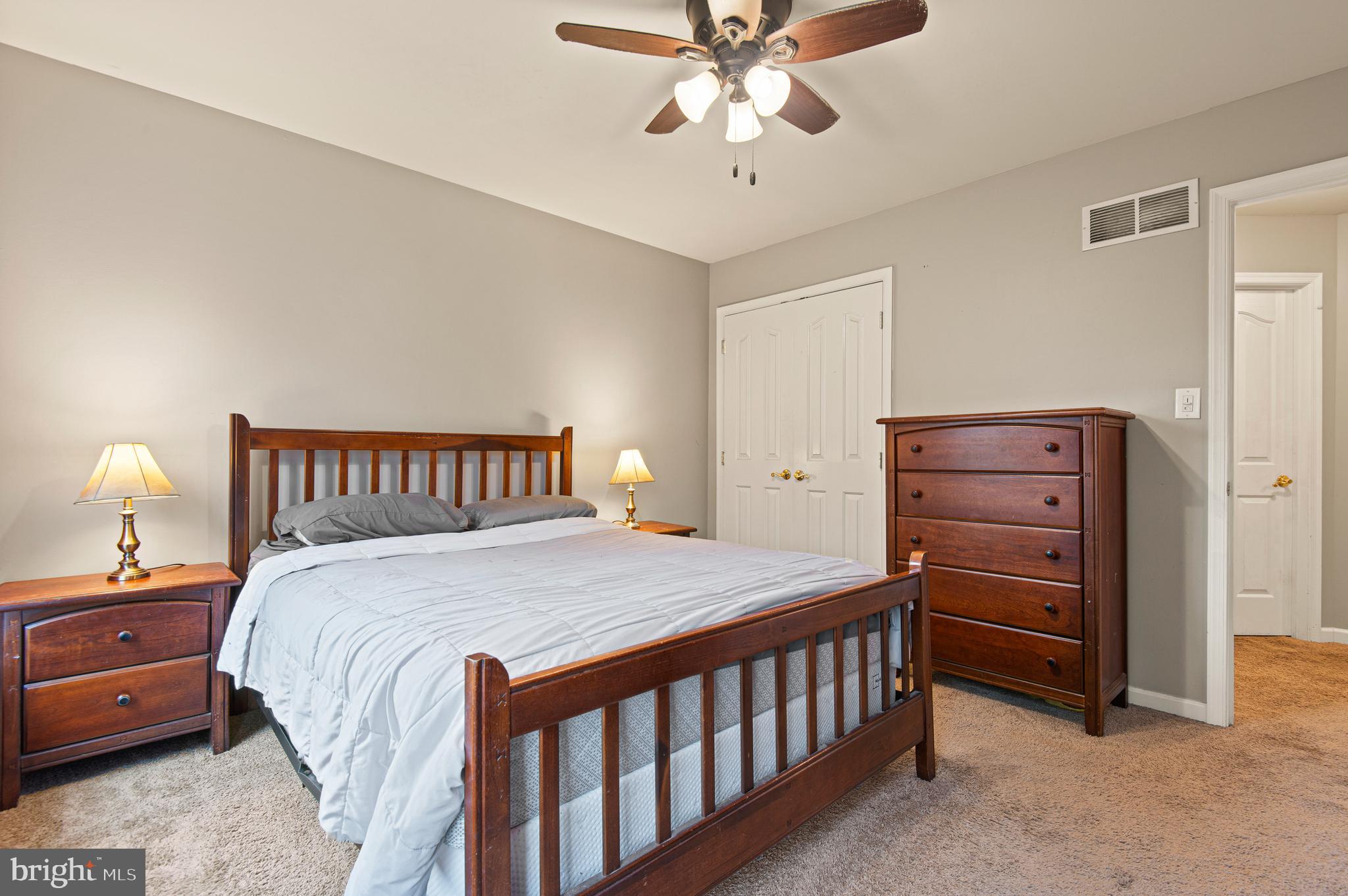 985 Silver Maple Circle Seven Valleys, PA 17360 - Photo 31 of 50 a bedroom with a bed and a chandelier