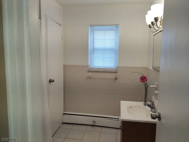 a bathroom with a shower a toilet and a window