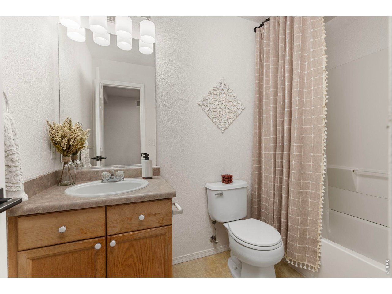 6531 St Vrain Ranch Boulevard Firestone, CO 80504 - Photo 21 of 30 a bathroom with a granite countertop toilet sink and mirror