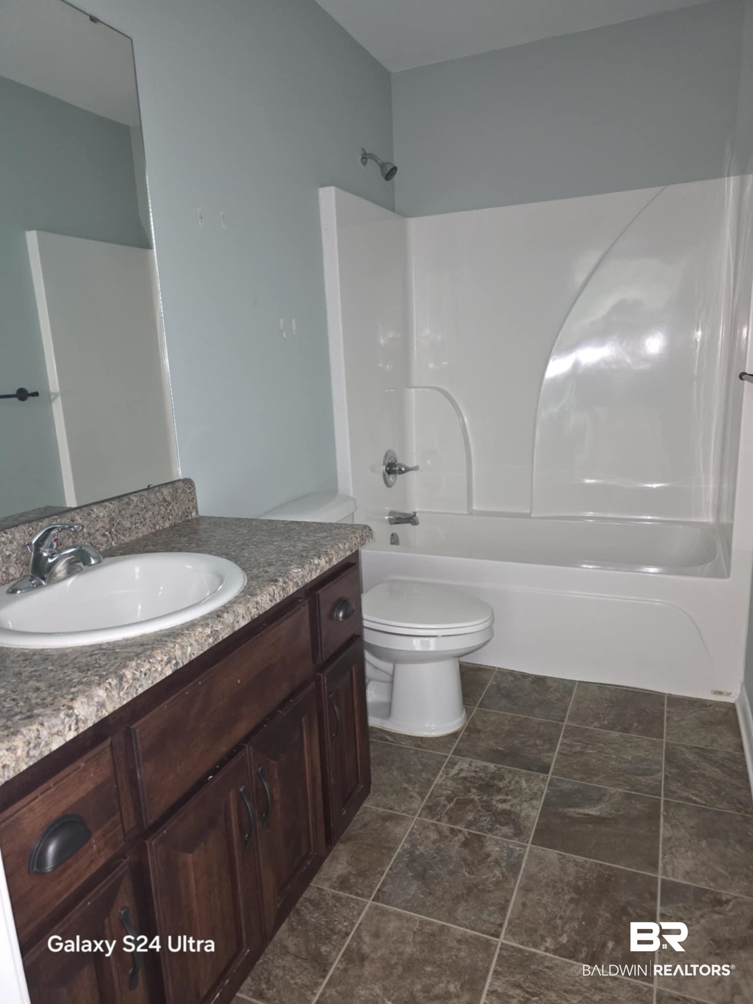 546 Wolf Log Road Flomaton, AL 36441 - Photo 11 of 15 Full bathroom with washtub / shower combination, toilet, tile patterned floors, and vanity