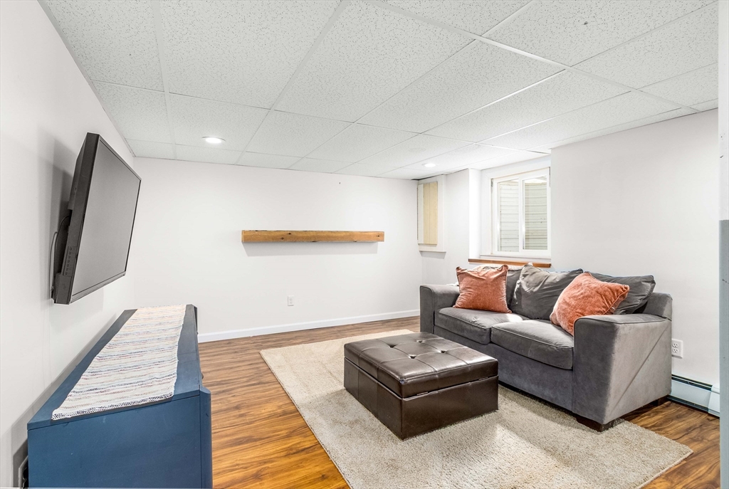 64 McNamara Road Yarmouth, MA 02673 - Photo 19 of 28 a living room with furniture and a flat screen tv