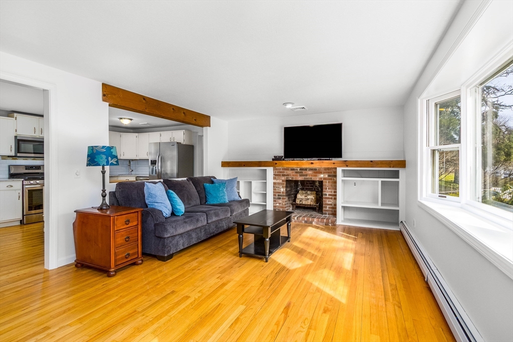 64 McNamara Road Yarmouth, MA 02673 - Photo 2 of 28 a living room with furniture and a fireplace