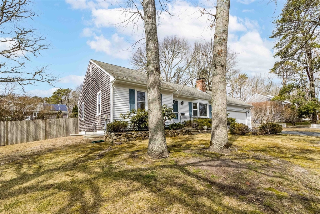 64 McNamara Road Yarmouth, MA 02673 - Photo 23 of 28 a house with trees in front of it
