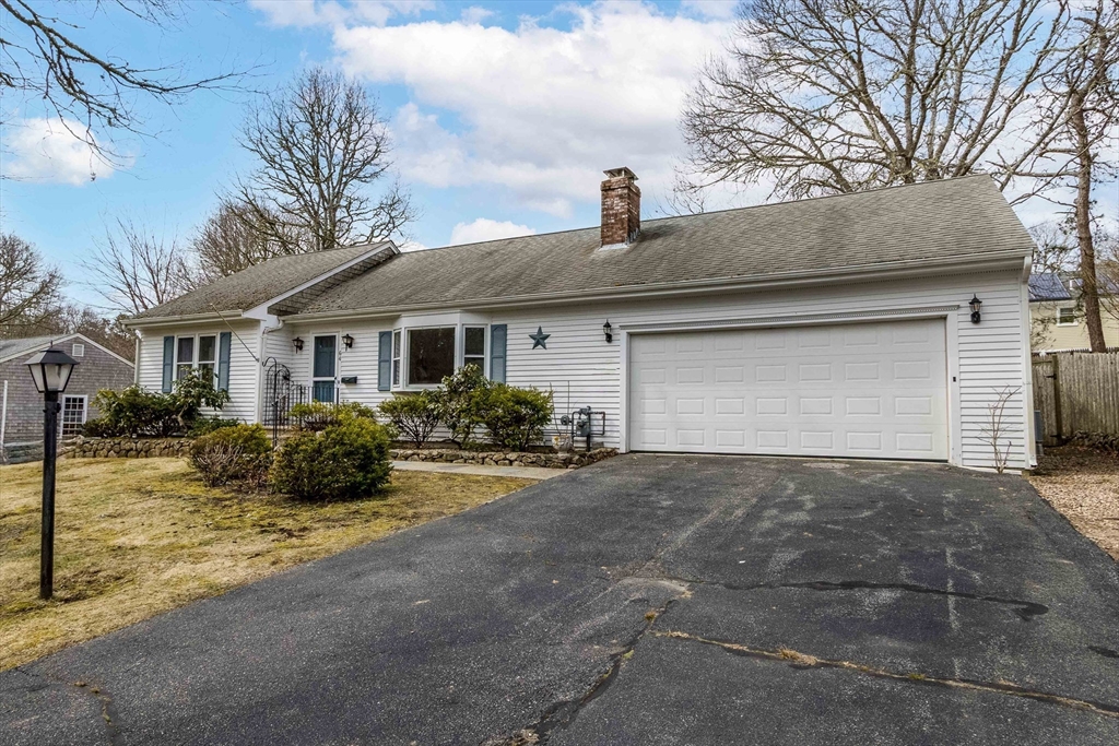 64 McNamara Road Yarmouth, MA 02673 - Photo 24 of 28 a view of a house with a yard and large trees