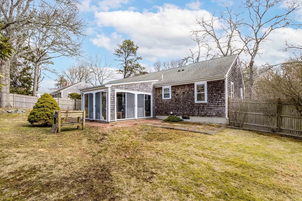 64 McNamara Road Yarmouth, MA 02673 - Photo 26 of 28 a view of a house with a large tree and a yard
