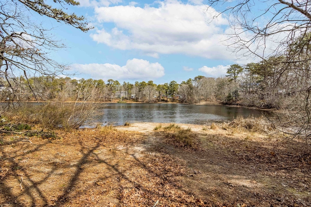 64 McNamara Road Yarmouth, MA 02673 - Photo 27 of 28 a view of a lake with houses in the back