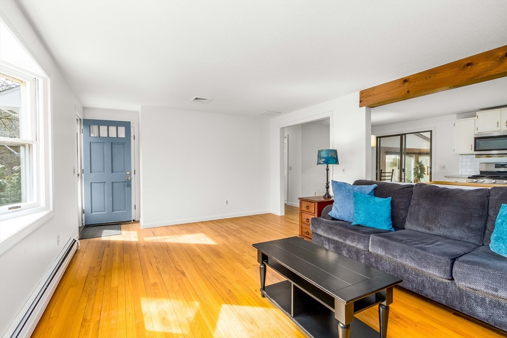 64 McNamara Road Yarmouth, MA 02673 - Photo 3 of 28 a living room with furniture and a table