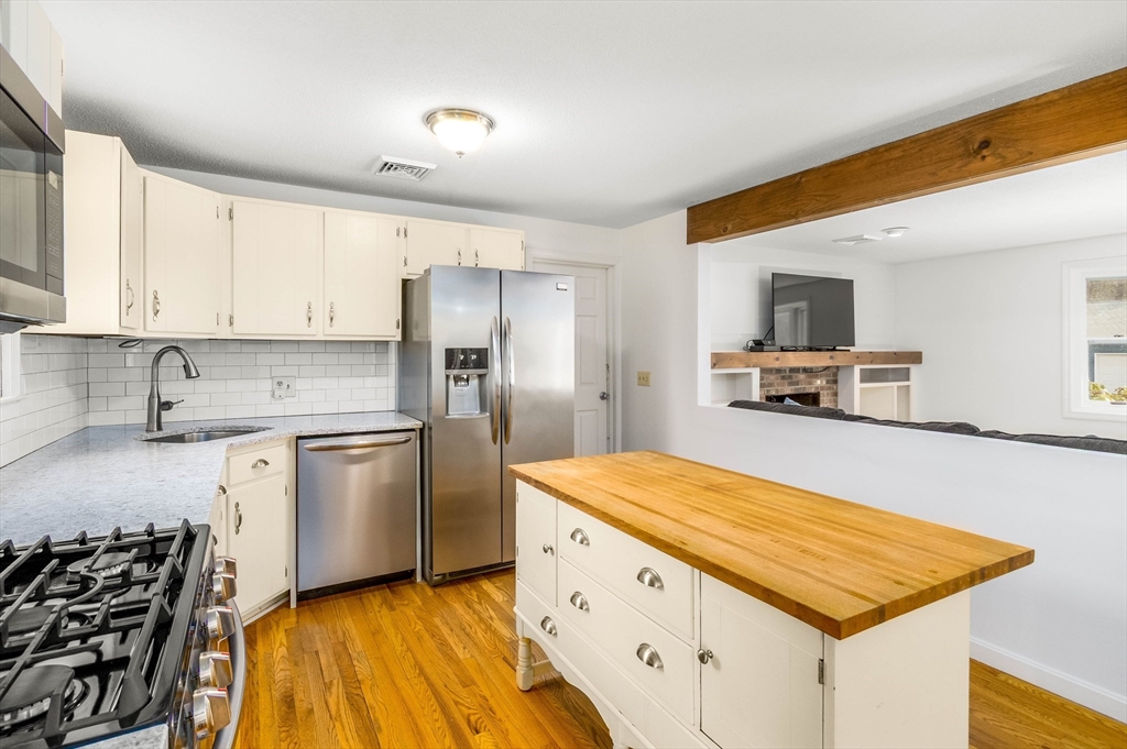 64 McNamara Road Yarmouth, MA 02673 - Photo 6 of 28 a kitchen with stainless steel appliances granite countertop a refrigerator and a stove top oven