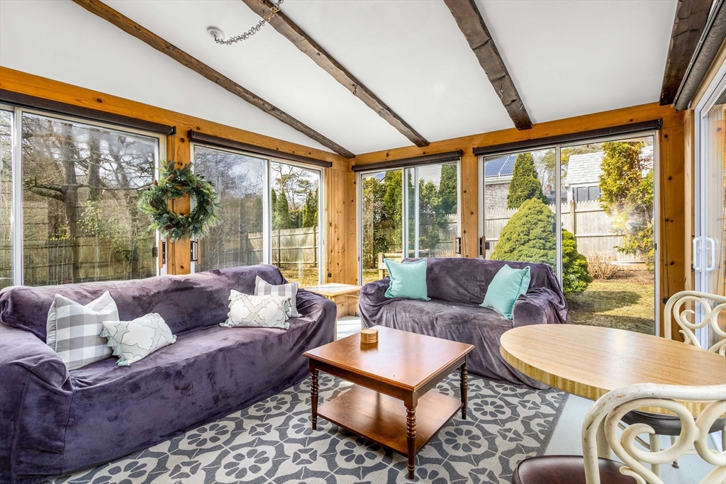 64 McNamara Road Yarmouth, MA 02673 - Photo 7 of 28 a living room with furniture and a large window