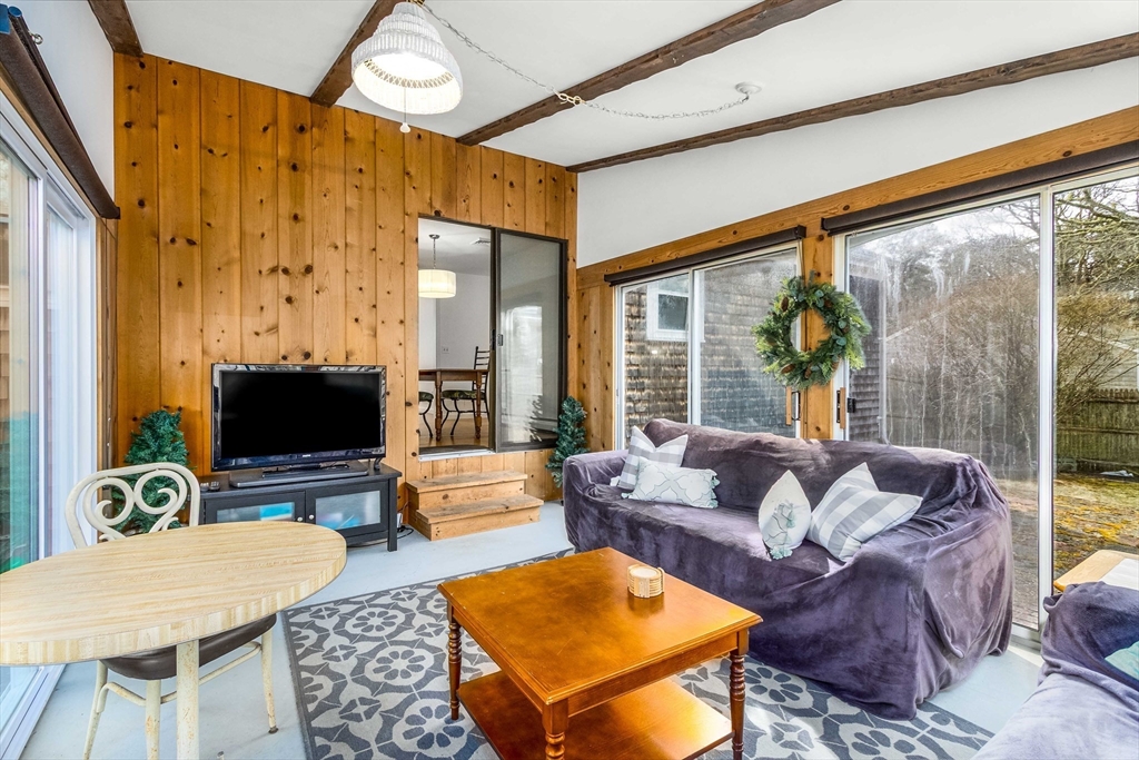 64 McNamara Road Yarmouth, MA 02673 - Photo 8 of 28 a living room with furniture and a flat screen tv
