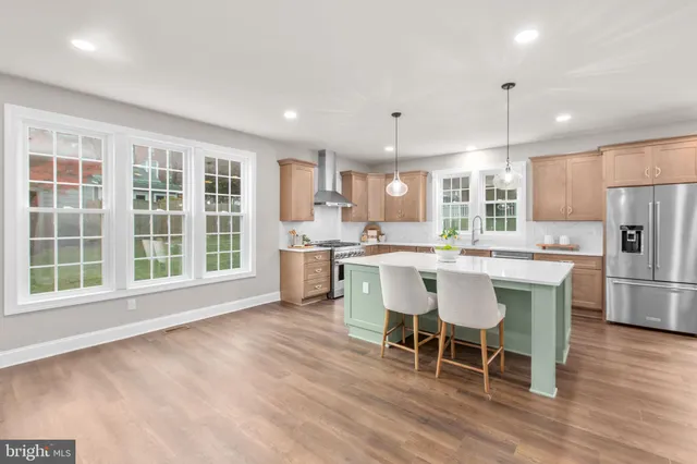 an empty room with wooden floor ceiling fan and a ceiling fan