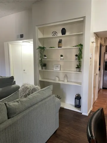 a living room with a baby crib and a couch