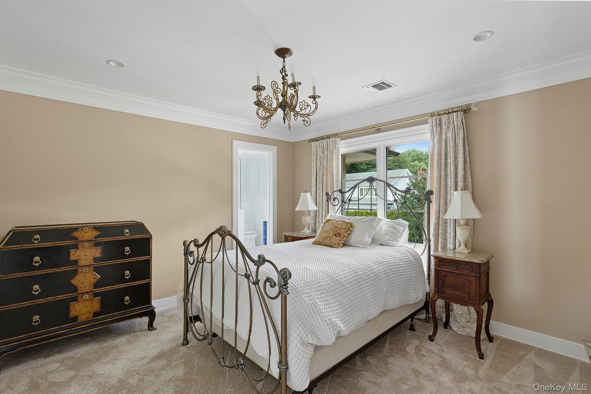 353 Centre Island Road Oyster Bay, NY 11771 - Photo 18 of 34 a bedroom with a bed and a chandelier