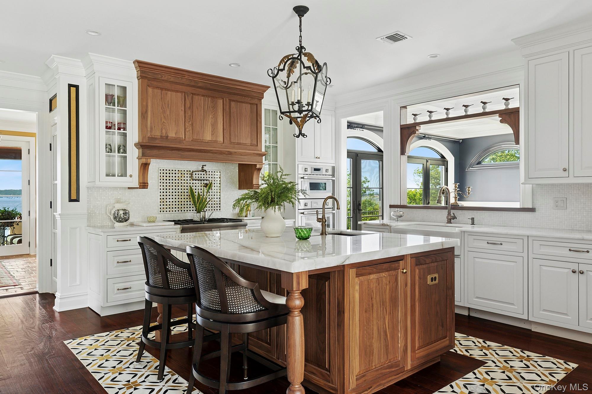 353 Centre Island Road Oyster Bay, NY 11771 - Photo 2 of 34 a kitchen with a table chairs and cabinets
