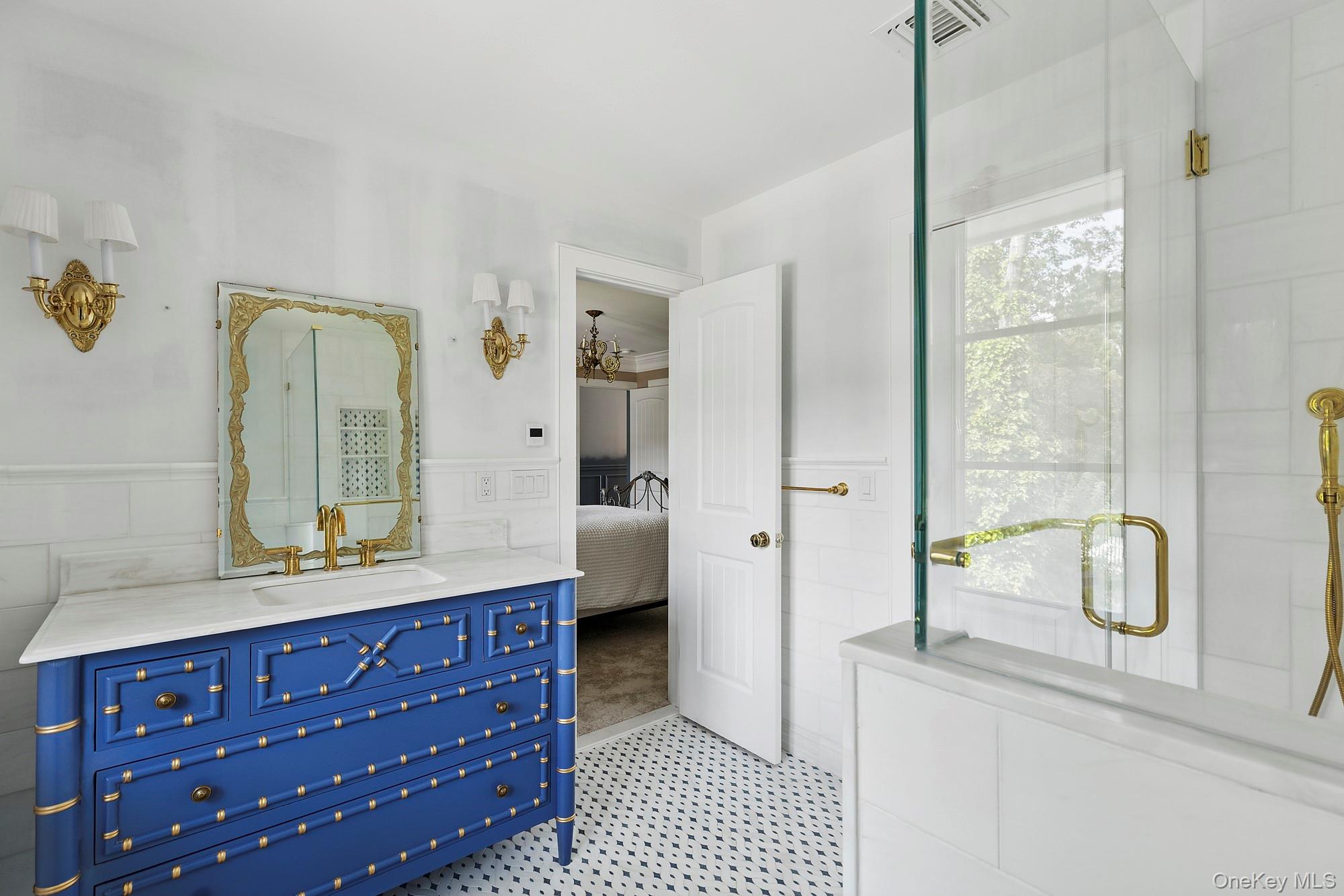 353 Centre Island Road Oyster Bay, NY 11771 - Photo 21 of 34 a bathroom with a double vanity sink a mirror and a bathtub