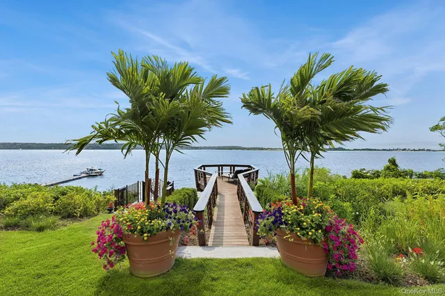 a view of a patio with a table and chairs under an umbrella