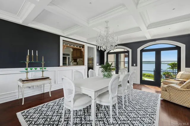 a living room with furniture and a large window with garden view