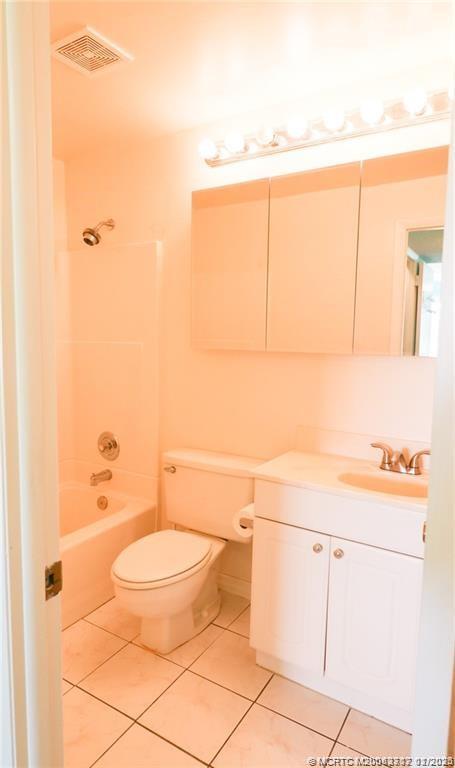 5433 Southeast Miles Grant Road, Unit 203 Stuart, FL 34997 - Photo 12 of 15 a bathroom with a toilet a sink and bath tub