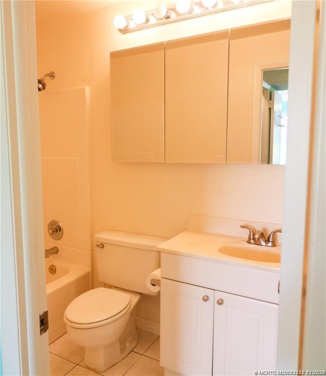 5433 Southeast Miles Grant Road, Unit 203 Stuart, FL 34997 - Photo 13 of 15 a bathroom with a sink a toilet and shower curtain