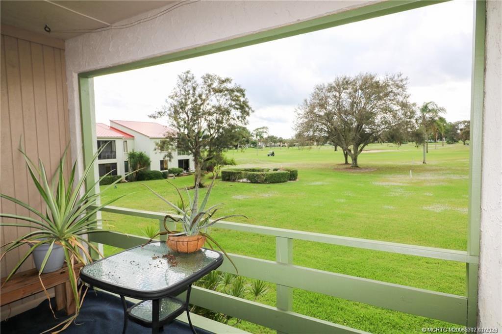 5433 Southeast Miles Grant Road, Unit 203 Stuart, FL 34997 - Photo 15 of 15 a view of an outdoor space and seating area