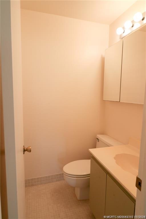5433 Southeast Miles Grant Road, Unit 203 Stuart, FL 34997 - Photo 6 of 15 a bathroom with a sink a toilet and vanity